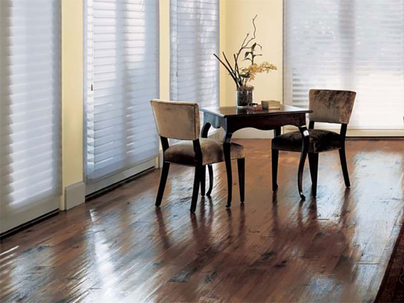 Dark hardwood with yellow walls and small table with two chairs