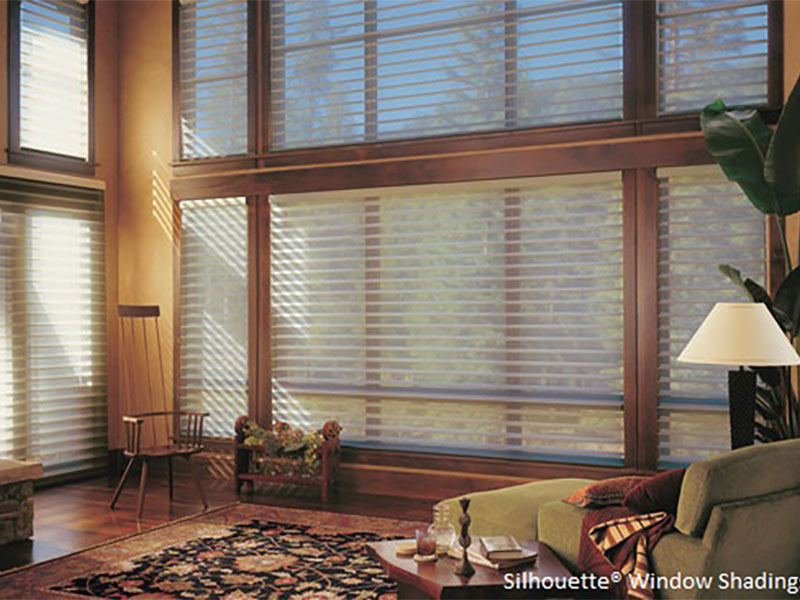 Living room with large windows and brown wood decor
