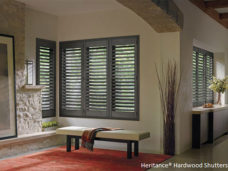 Grey window shades with white walls and red area rug