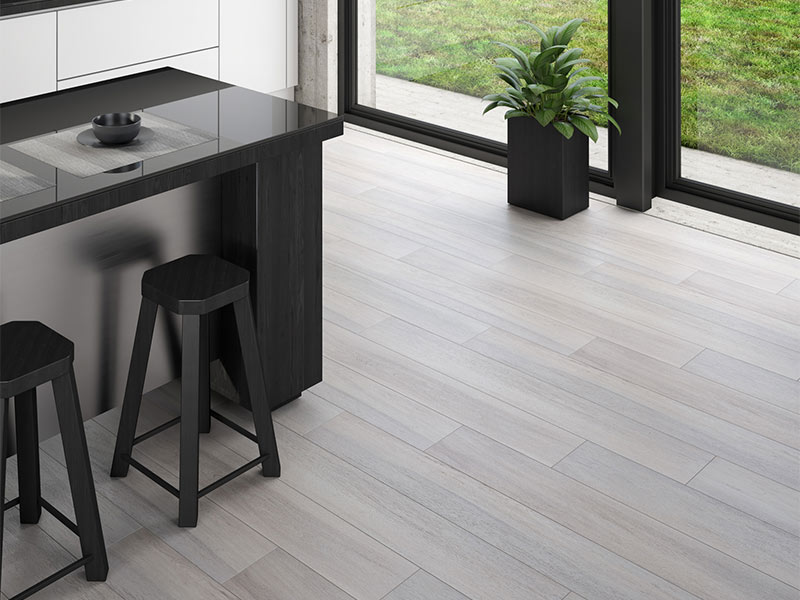 Grey tile floor with black chairs and kitchen island
