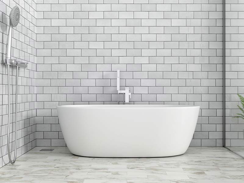 White tub with gray bathroom tile