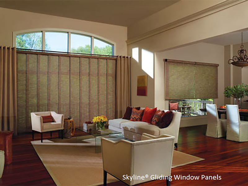 Living room with reddish hardwood and white walls and furniture