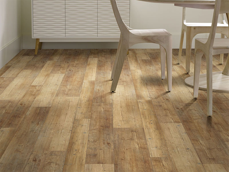 Wood-look vinyl flooring with wooden table and chairs and white furniture in background